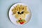 Dog on plate made of food. Vegetables art. Spagetti background. Kids eat. Lovely idea. Creative breakfast.