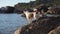 the dog put its paws on the stone on the beach. Jack Russell Terrier at sea. Active pet outdoors