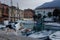The dog is sitting on the pier. Embankment in Italy, Lake Garda. Marble Australian Shepherd. Travel