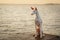 Dog at sunset by the sea. Ibizan greyhound in nature