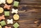 Dog tasty colored biscuits on wooden background with copy space