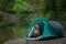 Dog in a tent in the rain. Nova Scotia Duck Tolling Retriever in the camp. Pet Travel