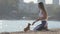 Dog training obedience concept of young sport caucasian woman train little chihuahua pet on summer city beach on sunrise
