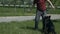 Dog training. Walking in a green park in summer. A man and a dog are playing with a stick. The owner takes a stick from