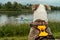 Dog watches as rowers on the river pass by