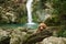 dog at the waterfall. Shiba inu in nature. Travel and hiking with pet