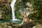 dog at the waterfall. Shiba inu in nature. Travel and hiking with pet