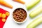 Dogfood, carrot and courgette on table background top view