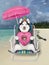 Dogicorn husky on beach chair with pink donut