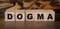 Dogma Word In Wooden Cubes. Social concept