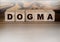 Dogma Word In Wooden Cubes. Social concept