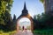 Dogs follow monks to alms bowls at front of the temple gate at Khao Na Nai Luang Dharma Park in Surat Thani Thailand