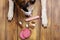 Dogs paws and neb and heap of forbidden dogs meal on wooden background