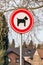 Dogs prohibited sign, round metal board with a red border with a drawing of a dog