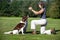 Dogs waiting for their dog biscuit from a woman