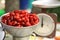 Dogwood berries in bowl for cooking jam with old mechanical scale