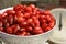 Dogwood berries in bowl for cooking jam with old mechanical scale