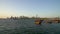 Doha Qatar skyline with traditional Qatari Dhow boats in the harbor