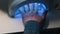 Doing manicure - hand of young woman in UV lamp gel polish manicure