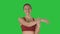 Doing stretching exercises Beautiful young woman doing stretching exercises while walking on a Green Screen, Chroma Key.