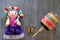 Doll and ball bearing, Mexican handmade toys and monarch butterfly on vintage wooden gray background