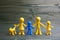 Doll family design with one different kid on wooden background. Autism symbol