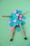 doll lies under a pile of blue and pink hearts, popularity in social media concept, top view