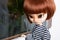 Doll red hairs face expressive portrait with big eyes standing window pretty fashion girl