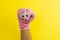 doll sock with googly eyes on a yellow background, hand theater
