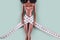 Doll wrapped in measuring tape. Tied up plastic doll, weight loss, fasting and slimming, diet, anorexia, eating disorder