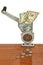 Dollar banknotes in meat grinder and coins on table.