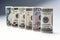 Dollar. Dollar banknotes roll in other positions. American US currency on white board and defocused background