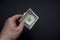 Dollar in hand. Top view of male hand holding a dollar banknotes. Currency paper money, bills in hand.