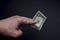 Dollar in hand. Top view of male hand holding a dollar banknotes. Currency paper money, bills in hand.