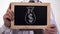 Dollar sack drawn on blackboard in doctor hands, expensive medicine, bribery