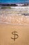 Dollar sign in the sand being washed away