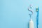 Dollar sign of toothpaste. Tube of colored toothpaste and a toothbrush on a blue background. Concept expensive dentist