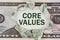 The dollar is torn in the center. In the center it is written - Core Values