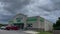 Dollar Tree retail store exterior building sign and parked cars storm clouds