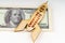 On the dollars lies a wooden model of a rocket with the inscription - EMERGING MARKETS