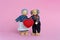 Dolls Elderly man and woman. Grandfather and grandmother hold a heart - a symbol of love and trust. Valentine`s day love