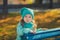 Dolly pin-up toothsome young girl wearing turquoise light blue jacket and warm hat fashion stylish clothes posing in autumn spring