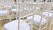 Dolly of rows of chairs at a wedding ceremony from the aisle and from the back