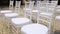 Dolly of rows of chairs at a wedding ceremony from the aisle and from the back