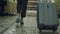 Dolly shot of legs of businesswoman walking through hotel lobby pulling luggage and stop at reception desk. Business