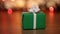 Dolly shot of present box against blurry lights