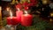 Dolly shot of table decorated with burning candles, wreath and gifts for Christmas