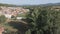 Dolly zoom over old small village, trees and river