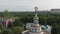 Dolly zoom to monument of Soviet woman with wheat in hands. View to Exhibition Center VDNG in Kyiv.