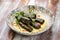 Dolma in grape leaves with lamb on mushroom julienne. Haute cuisine. On a wooden background